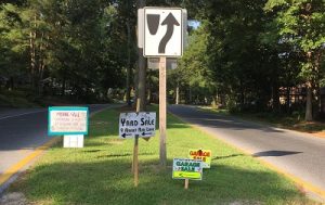 yard sale signs on a lawn