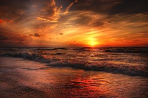 Bright orange and red sunrise over the ocean