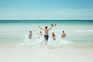 Group running into the waves