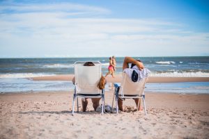 Couple on beach chairs looking at the water