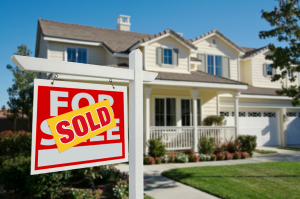 Sold sign in front of a single-family home.