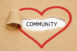 brown paper with a red heart around the word community
