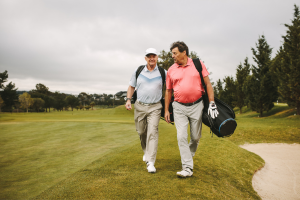 Two men walking on a golf course